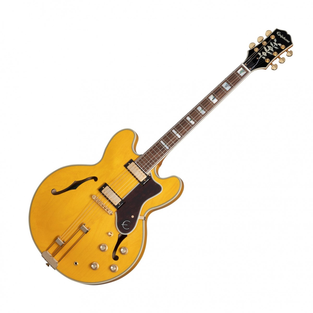 En bild på Epiphone Sheraton Frequensator Natural | Epiphone Sheraton Frequensator är en gitarr som kombinerar vintage med contemporary spelbarhet. Blueslegendaren John lee Hookers utvalda Epiphone detta anrika instrument har en halv-ihålig kropp gjord av lagerlönn med en mittblock i lönn för återkopplingsmotstånd. Den 22-bandade mahognyhalsen har en inbunden indisk lagerbräda med block av pearl med abalone triangle. En SlimTaper 60s C-profil på halsen gör det enkelt och bekvämt att spela under längre perioder medan gold inklusive en vintage-stil Frequensator Split Trapeze Stränghållare lägger till den enkla och tidlösa estetiken hos denna Epiphone-legend.  Det är dags att leverera. Och Epiphone ProBucker mini humbuckers tar fram det bästa inom vilken musikgenre som helst. De har ett brett dynamiskt tonområde vilket gör den här gitarren till ett utmärkt val för alla musiker som söker mångsidighet. Med två volym- och två tonkontroller kan du hitta ett ljud som passar din stil oavsett om du spelar jazz rock eller blues. Denna gitarr kommer med en premium väska som håller ditt instrument säkert under transport och förvaring. Väskan är designad för att passa gitarren tätt och ger maximalt skydd mot stötar och repor så att du kan ta din Sheraton Frequenator vart du än går. Sammantaget är Epiphone Sheraton Frequenator ett utmärkt val för alla som letar efter ett klassiskt utseende och vintage i en modern gitarr.