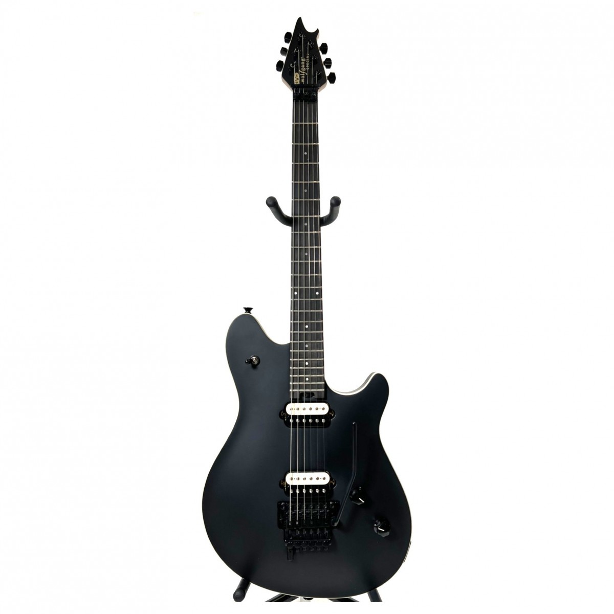 En bild på EVH Wolfgang Special EB Stealth Black - Ex Demo | Ex-Demo Serienummer: WG223366M Tekniska noter Gitarren har några små repor. Den här produkten har kvalitetskontrollerats av en av våra reparationstekniker för att säkerställa att den uppfyller en hög spelstandard.  Den fotograferade produkten är den enskilda produkten som kommer att tas emot.   Förbered dig för strålkastarljuset. Ta bort foten från bromsen och vrid gainen till 11 med en gitarr byggd för scenen. EVH Wolfgang Special EB tar din uttrycksfulla lead licks tempohungriga tapping och slagkraftiga powerackord och sätter dem i centrum tack vare de anpassade Wolfgang alnico 2 humbucking-pickuperna. Den fantastiska Ebenholts greppbrädan och den kvartssågade handgjorda lönnhalsen som är skuren enligt Eddie Van Halens exakta specifikationer ger en exakt artikulation och gränslös spelbarhet.  När fansen skriker efter mer måste du ge dig in i nästa låt oavsett vilken stämning den har. EVH Wolfgang är utrustad med ett patenterat EVH D-Tuna -system så att drop-D-stämning bara är en knapptryckning bort. Show-stoppande squeals och pitch bends kommer naturligt för Wolfgang Special Den är utrustad med en industristandardiserad EVH-märkt Floyd Rose låst tremolo. Kombinerat med den matchande låsSadeln får du ultimat stämningsstabilitet genom de mest extreme divebombs och bends. Kliv ut ur skuggorna? Du kan lika gärna hoppa!
